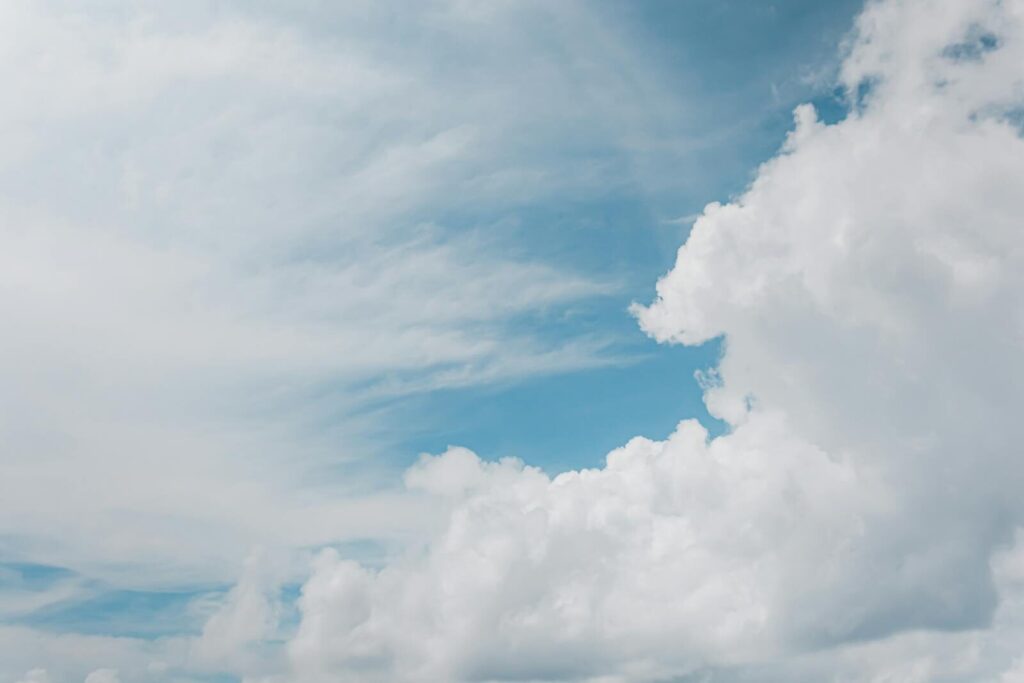 A serene view of blue sky and white fluffy clouds, creating a peaceful atmosphere.