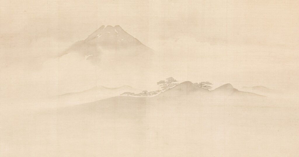 Misty mountain landscape with trees and fog.