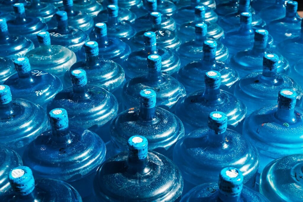 Rows of blue plastic water cooler jugs